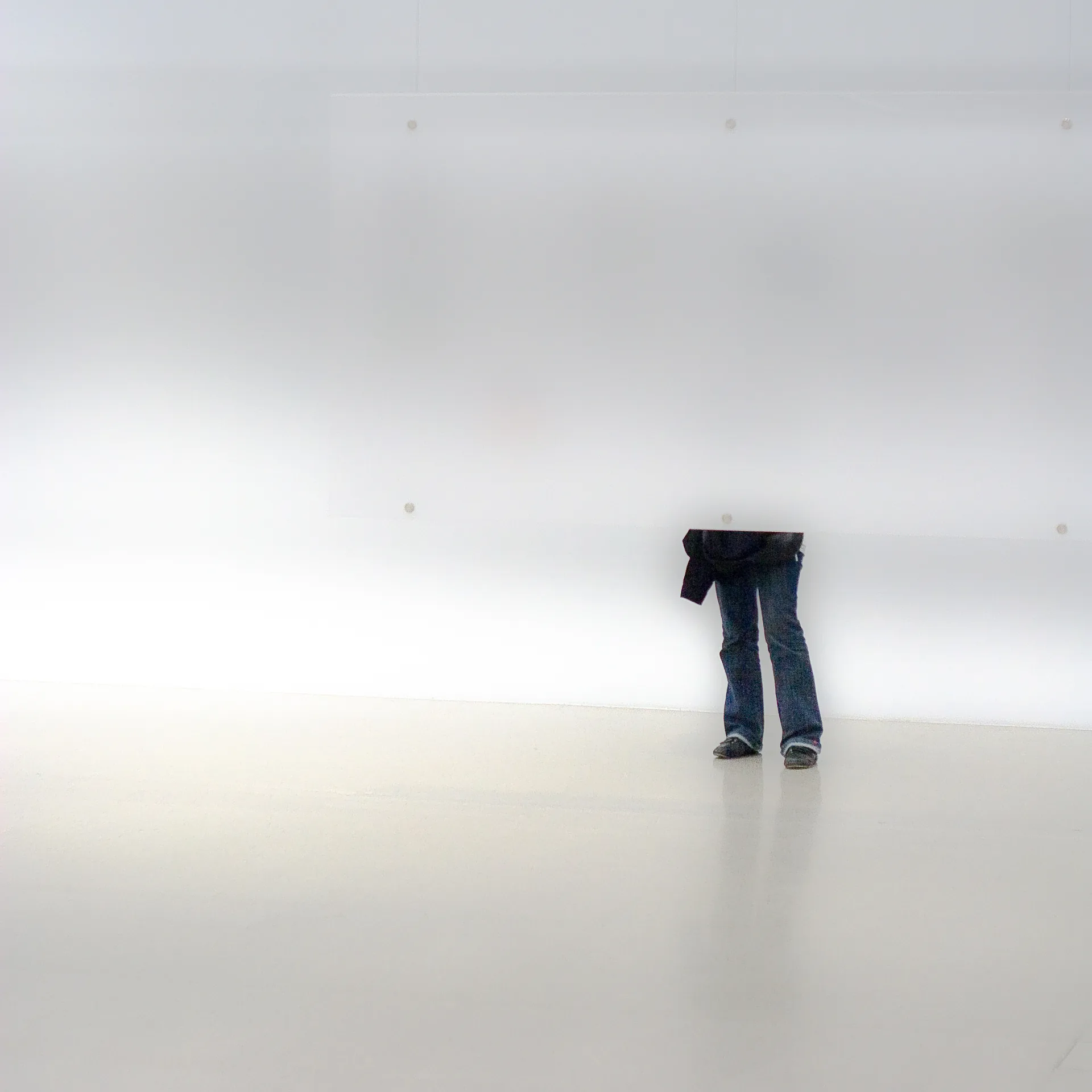 Eine Jeans steht allein in einem weißen Raum