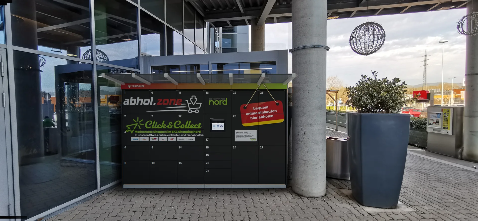 Derselbe Eingang mit eingefügter Abholstation neben der Glastür
